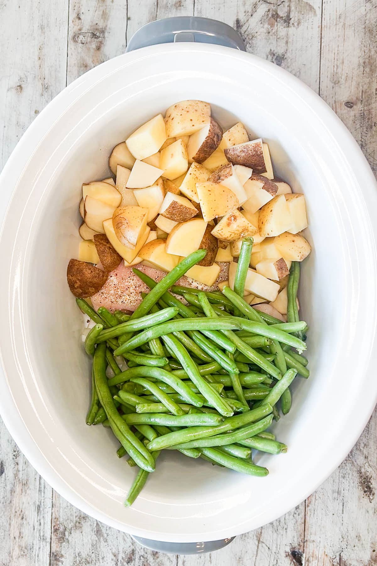 How to make slow cooker chicken and potatoes step 4: add green beans to the crockpot.