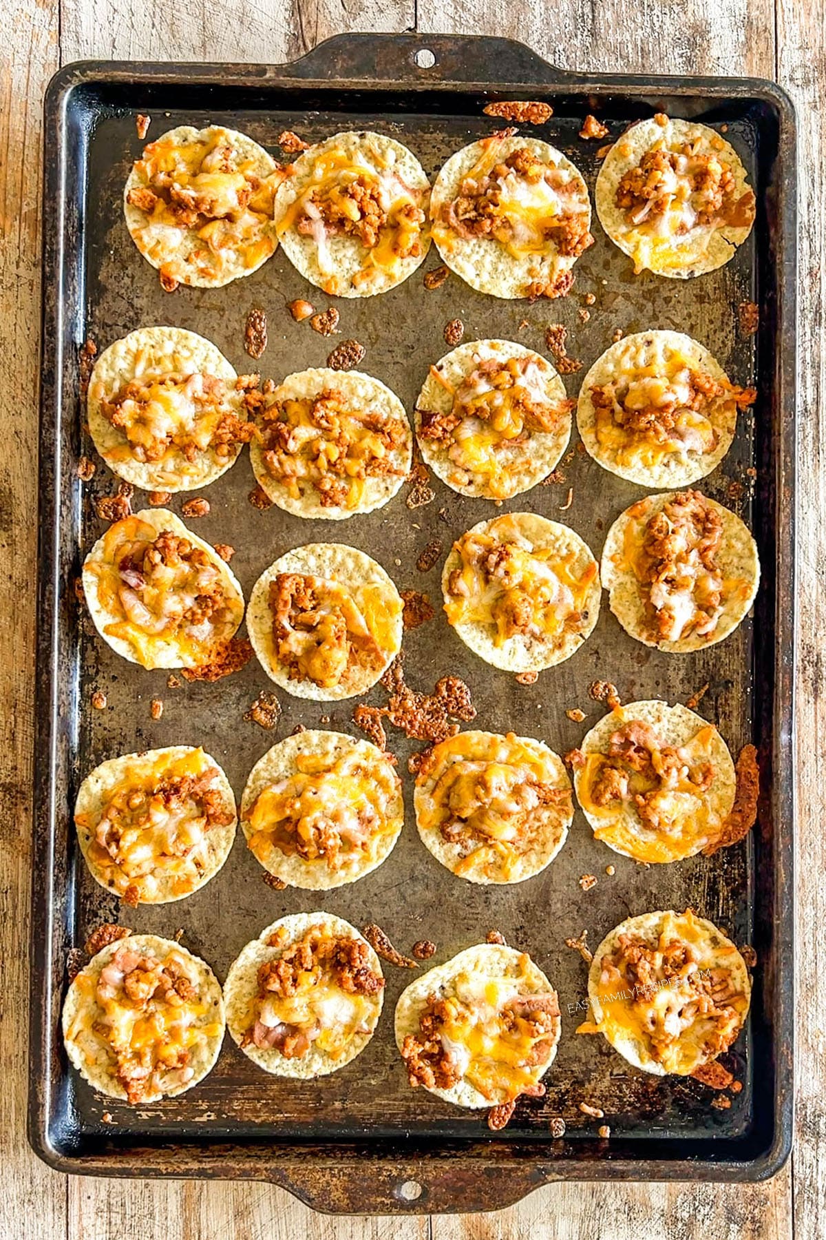 Step 4 of making Tiny Tacos - the chips are baked until warm and the cheese is melted.