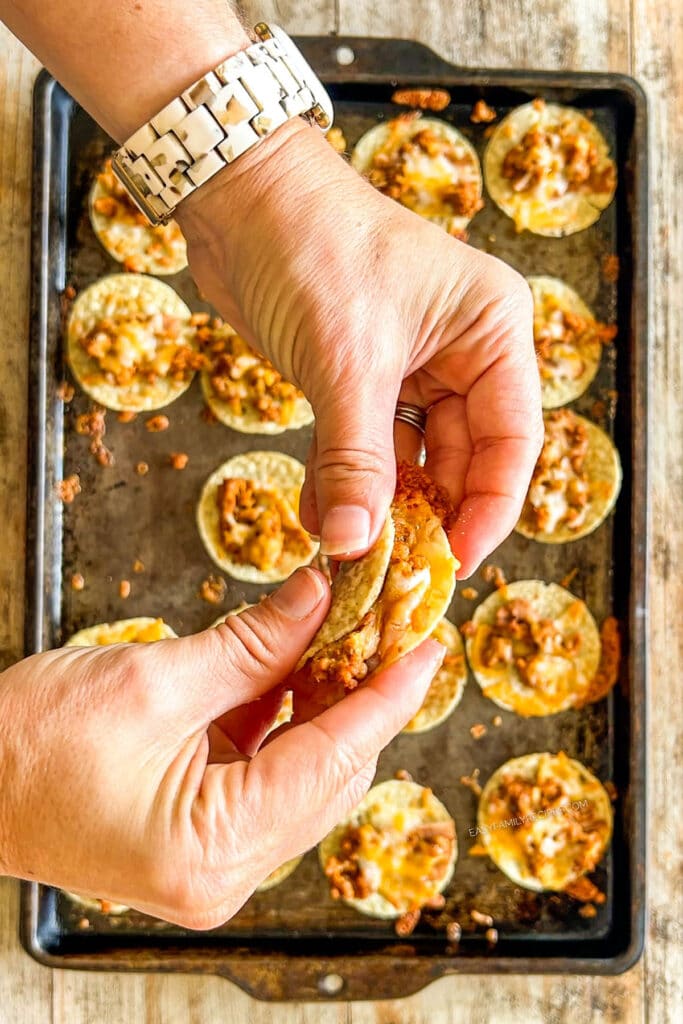 Step 4 of making Tiny Tacos - each chip is folded over by hand.