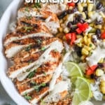 Top view of a Southwest Chicken Bowl in a white ceramic bowl. Two lime wedges garnish the top. The text reads, "Southwest Chicken Bowl"