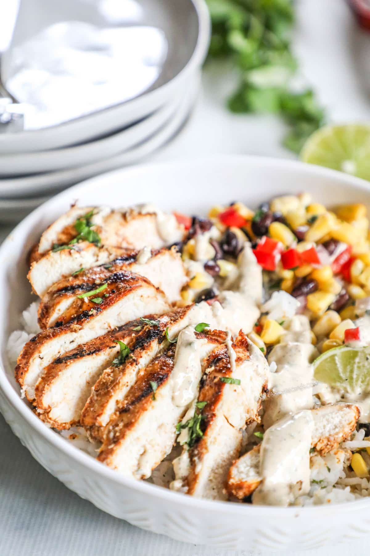 A white ceramic bowl full of Southwest Chicken Bowl ingredients.