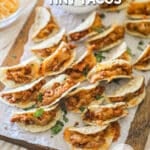 Tiny Tacos on a parchment-lined wooden board. The text reads, “Beef and Bean Tiny Tacos.”