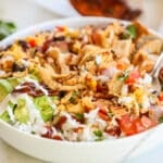 BBQ chicken bowls in a white bowl with a silver fork.