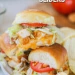 A pile of chicken tender sliders on a white plate with potato chips and a tomato in the background. The text reads, "Chicken Tender Sliders"