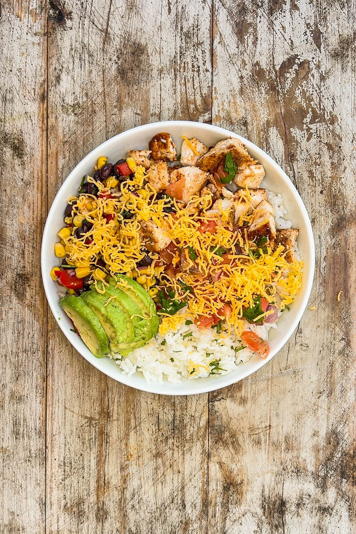 Step 4 of making BBQ chicken bowls: Add the avocado.