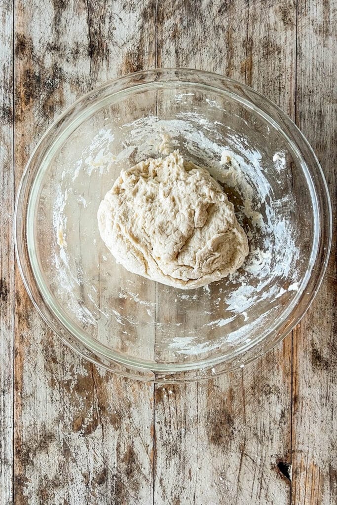 a tortilla dough ball in a mixing bowl.