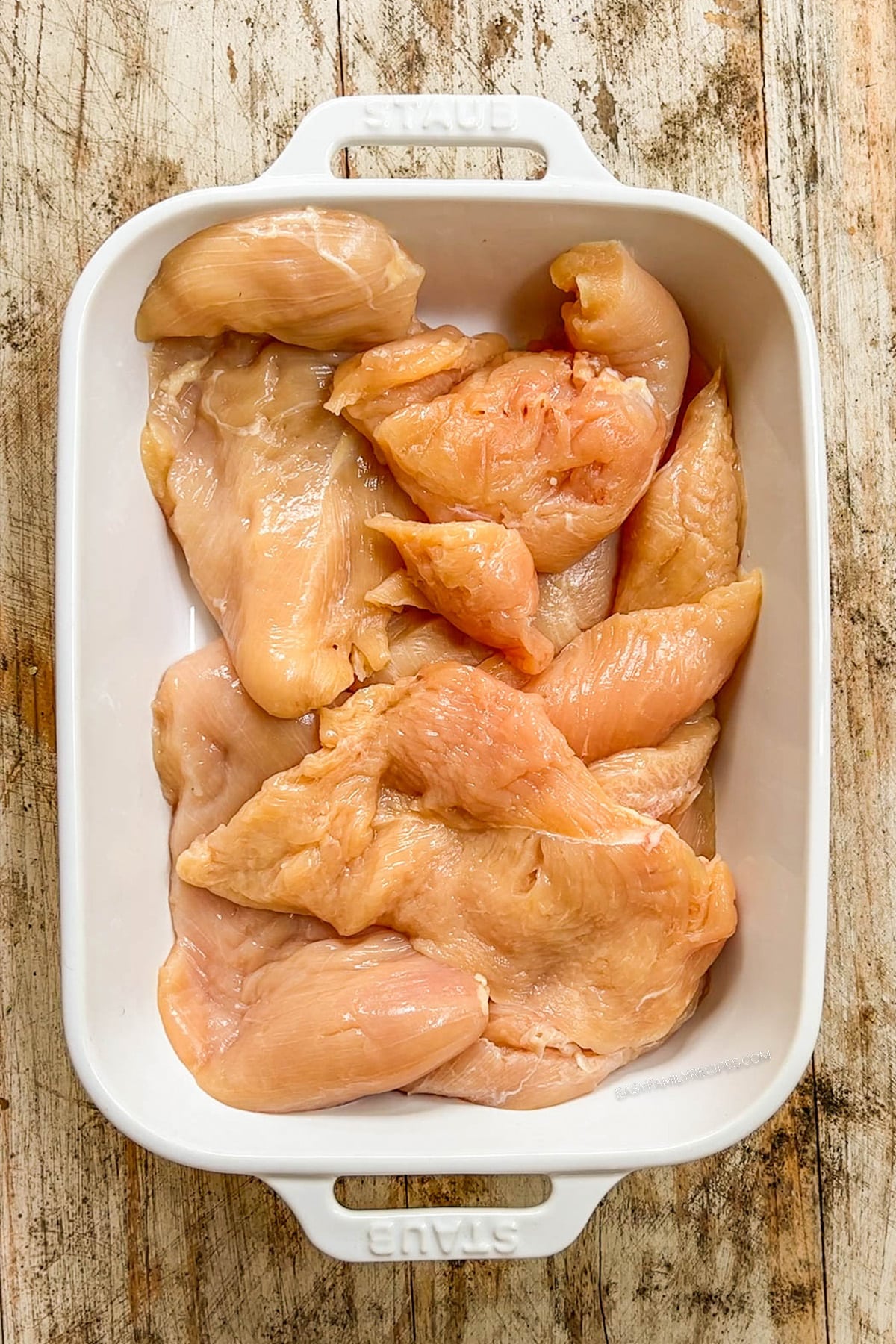 Step 1 for making Hot Honey Chicken Tenders: Place the chicken tenders in a baking dish.