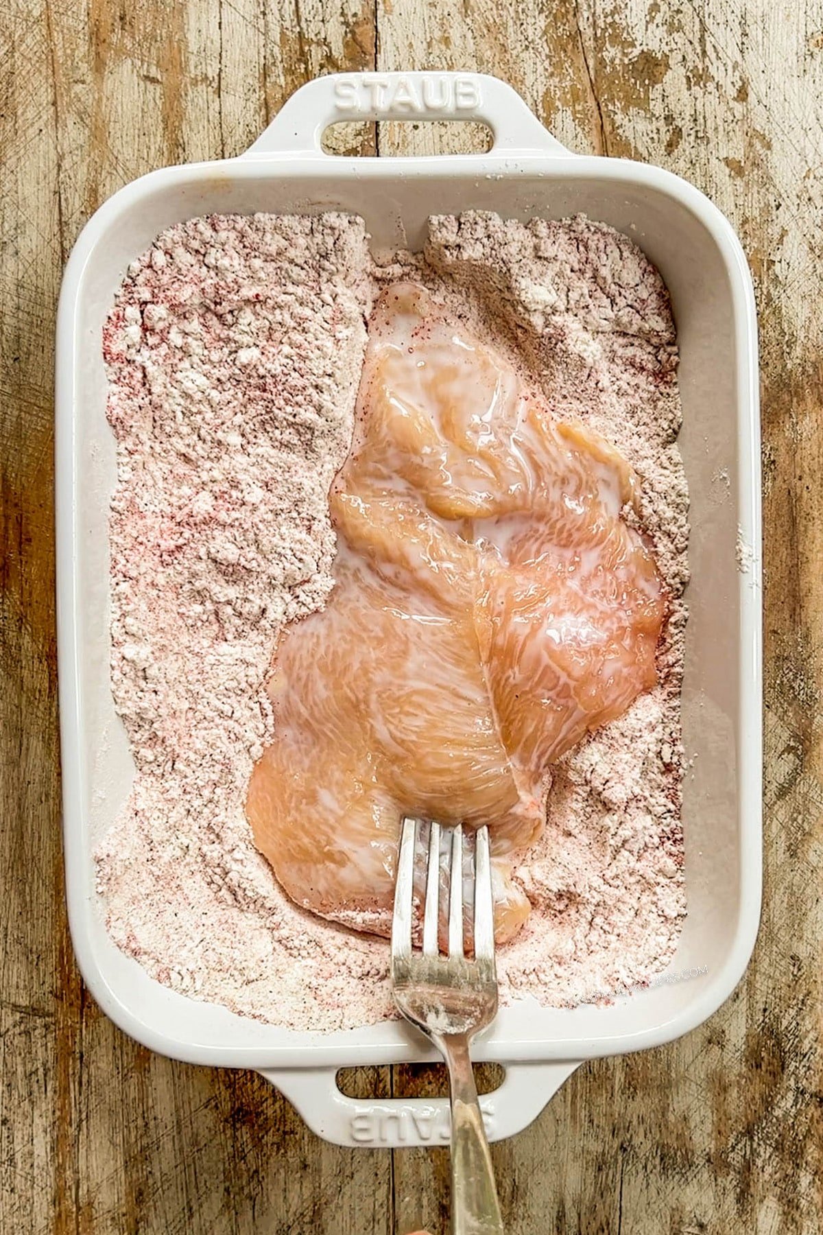 Hot Honey Chicken Tenders step 3: Dredge the chicken in the flour and seasoning mixture.