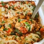 A silver serving spoon scoops out a serving of turkey stuffed pepper casserole.