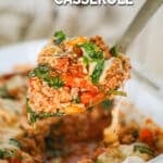 A silver serving spoon lifts a serving of ground turkey stuffed pepper casserole out of a white baking dish. The text reads, "Turkey Stuffed Pepper Casserole."