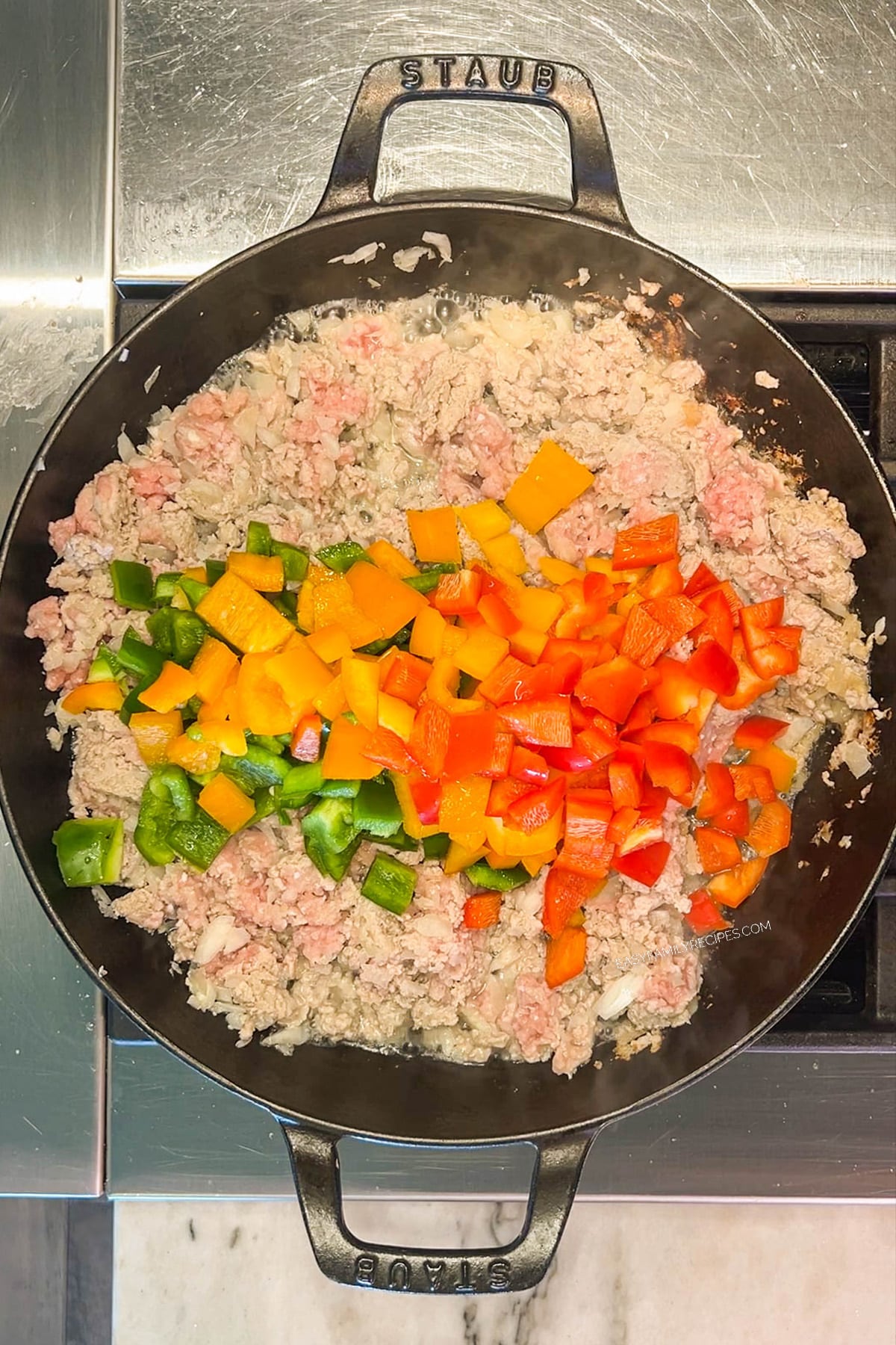 Peppers are added to the cooked turkey for stuffed pepper casserole.