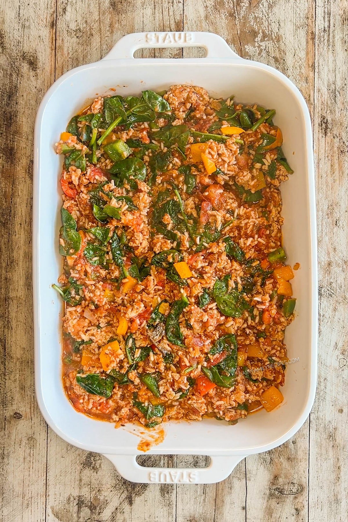 Ingredients for turkey stuffed pepper casserole are added to the 9x13 baking dish.