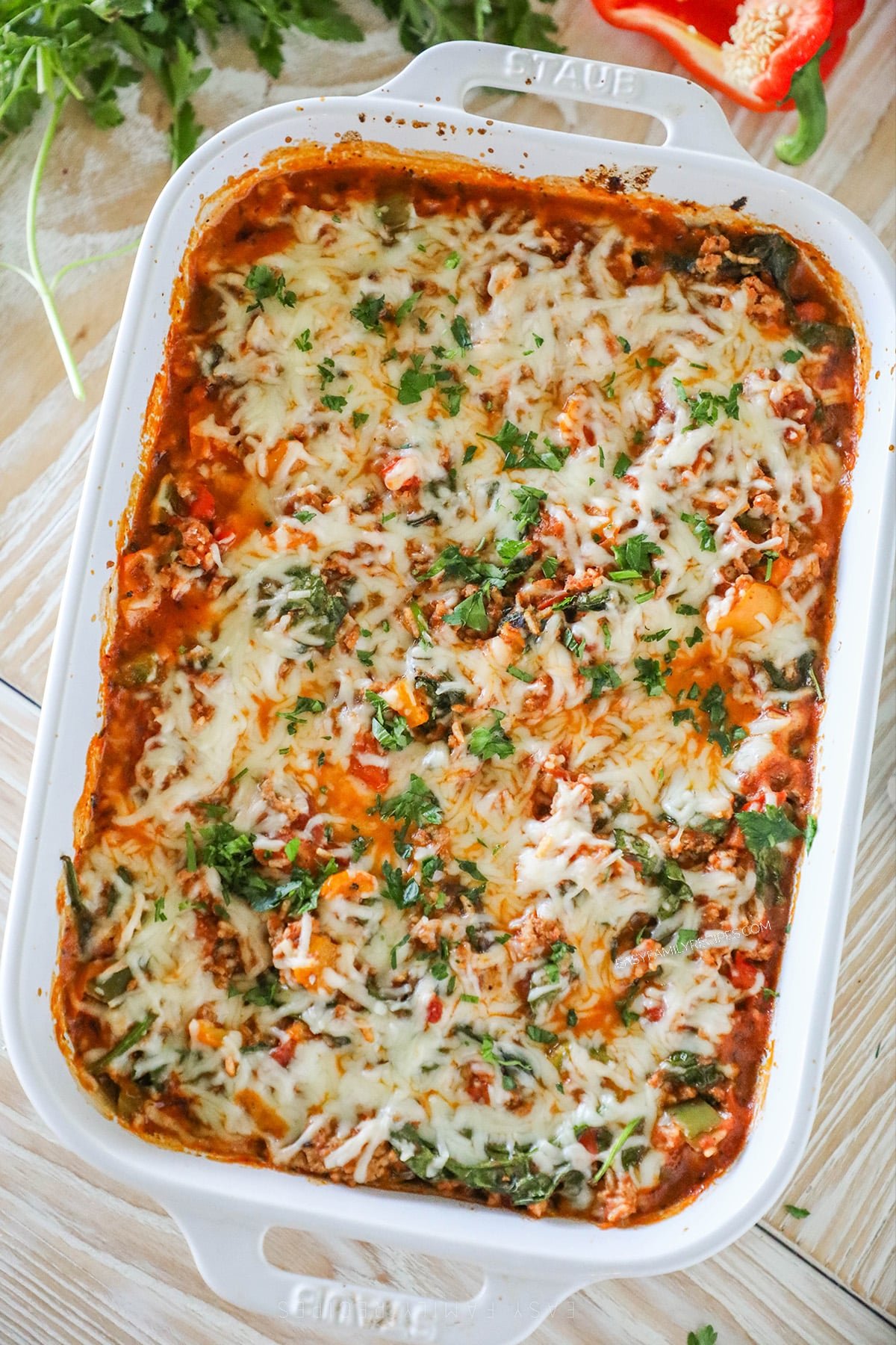 A white 9x13 inch casserole dish with turkey stuffed pepper casserole inside.