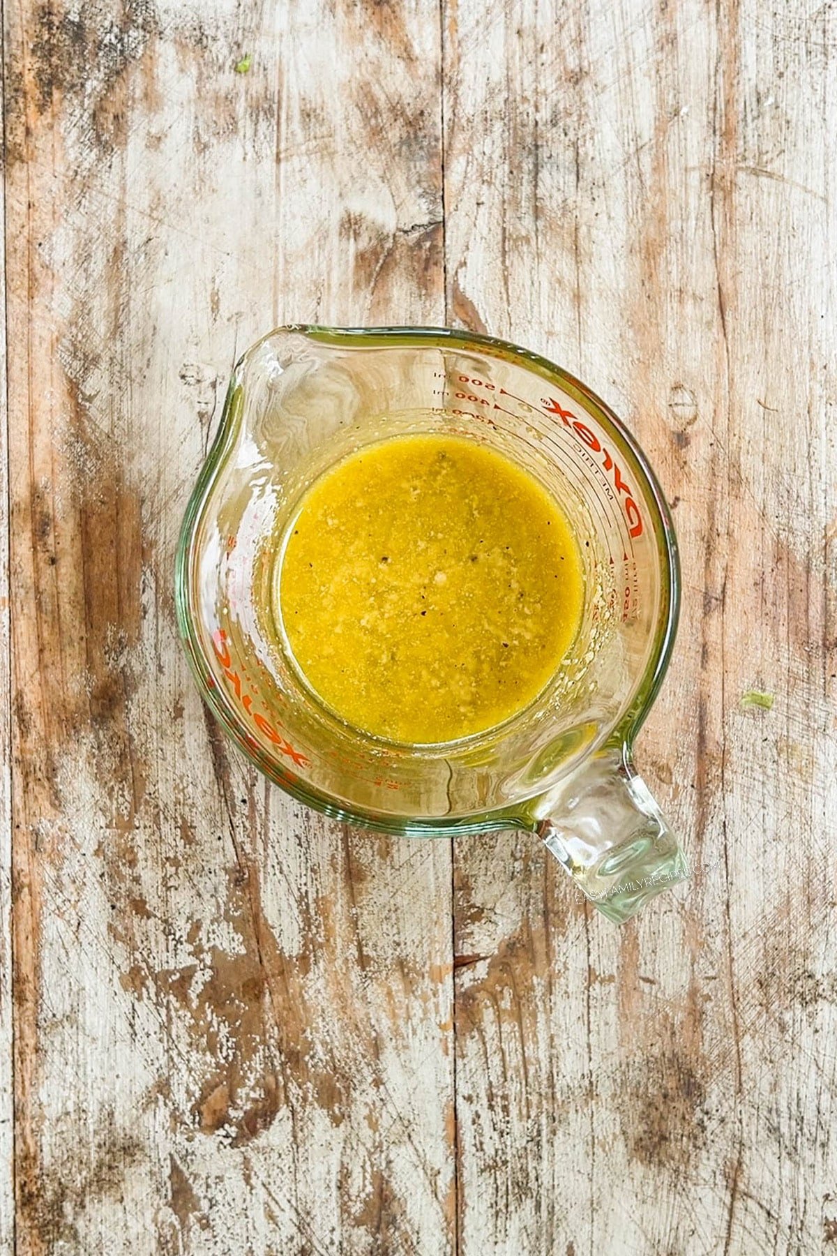 vinaigrette salad dressing in a measuring glass.