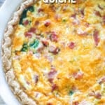 Top view of a ham and spinach quiche in a white pie plate. The text reads, "ham and spinach quiche"