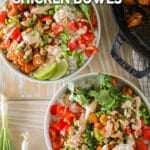 Easy chili crunch chicken bowl assembled in a bowl with dressing drizzled on top.