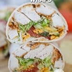 Chicken tender wrap cut in half and stacked on a wooden board. The text reads, “Chicken Tender Wraps”