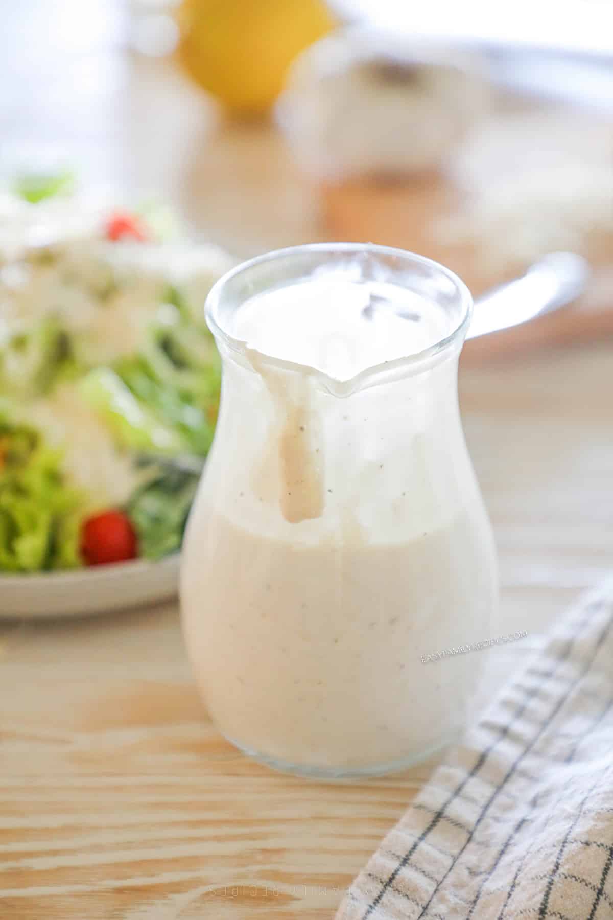 a half full container of creamy parmesan dressing.