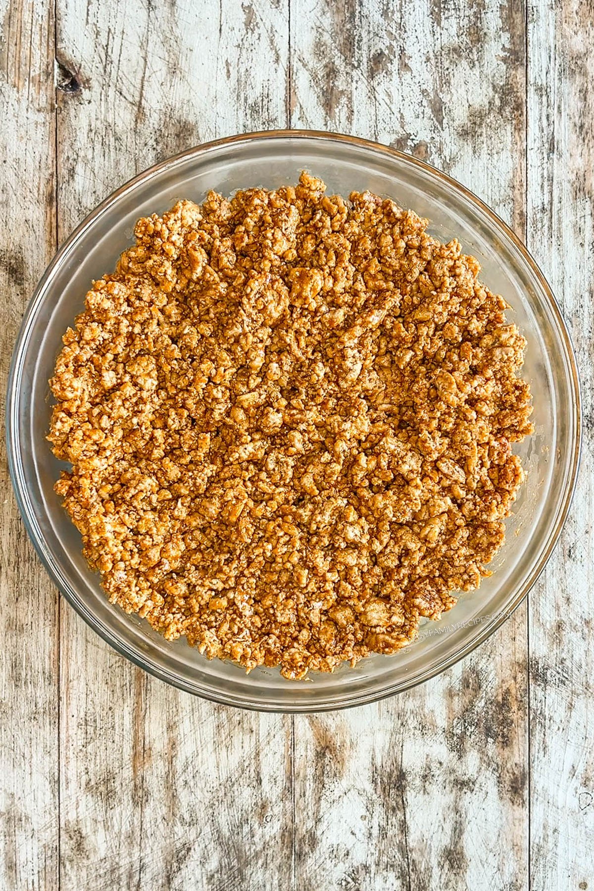 Taco meat is added to the bowl for layered taco salad