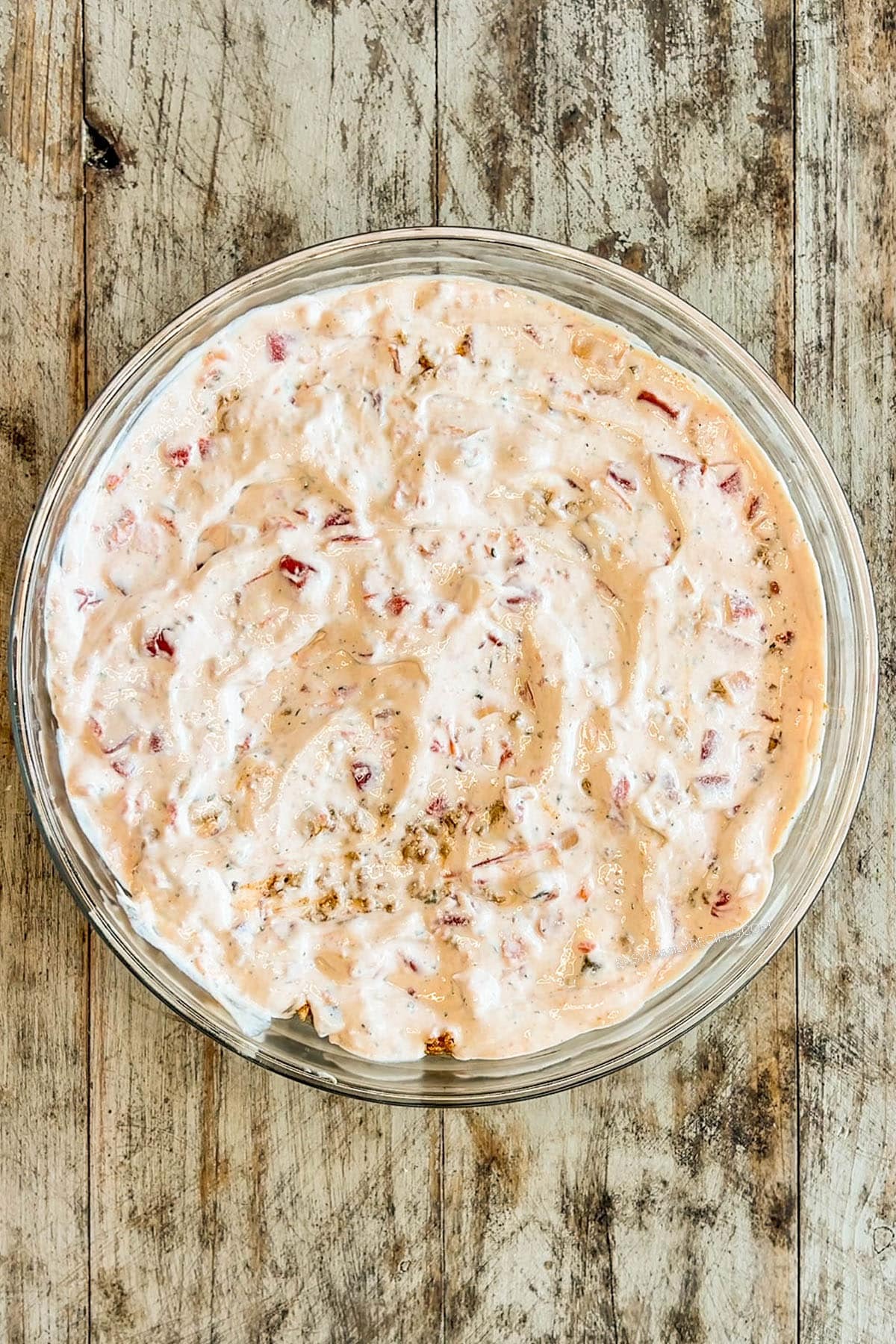 Salsa ranch dressing is added to the bowl for layered taco salad