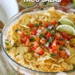 Layered Taco Salad in a glass bowl. The text reads, "layered taco salad"