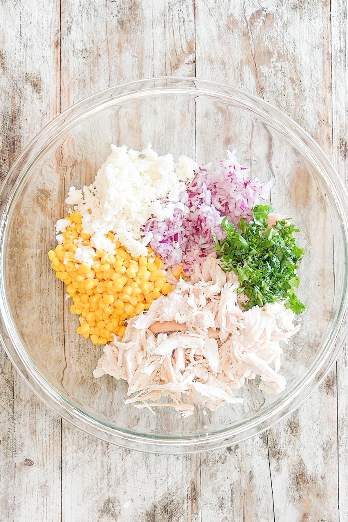 Ingredients for Street Corn Chicken Salad in a mixing bowl