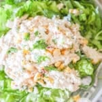 Top view of street corn chicken salad on a bed of lettuce. The text reads, "Mexican Street Corn Chicken Salad"