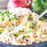 Street Corn Chicken Salad in a gray bowl with a silver spoon in it.
