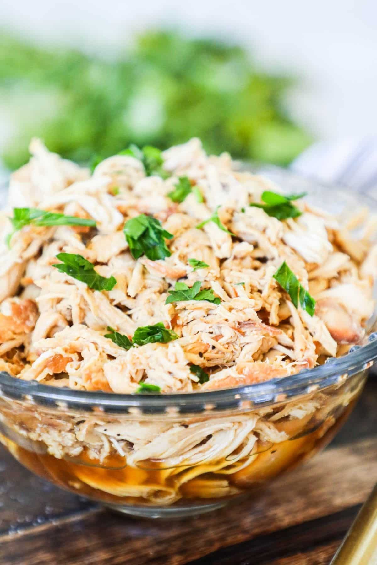glass bowl filled with shredded honey garlic chicken
