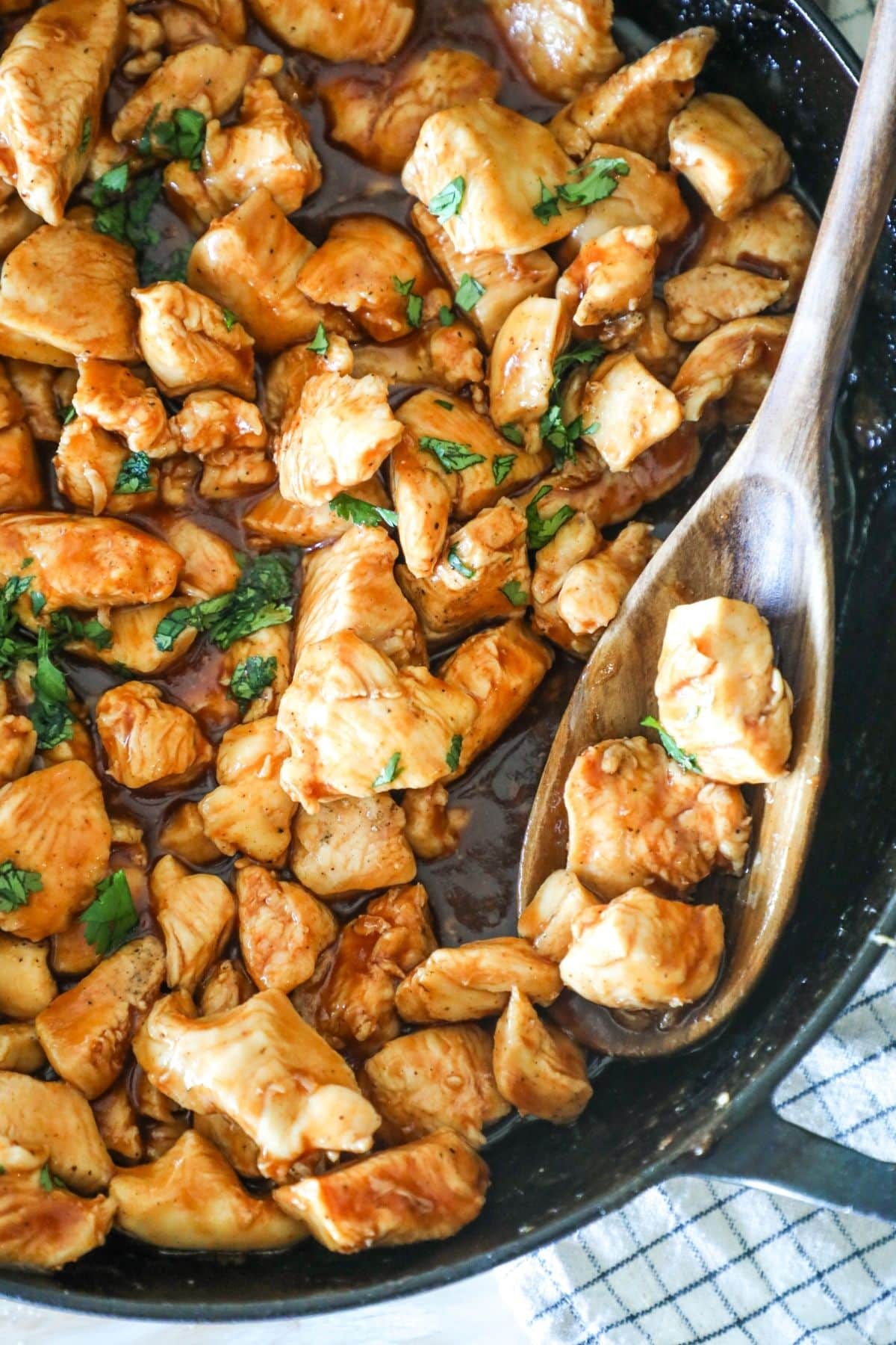 skillet with spoon, filled with honey bbq chicken bites