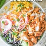 Top view of honey bbq chicken in a white bowl on a whitewashed wood background. The text reads, "Honey BBQ Chicken Bowl"