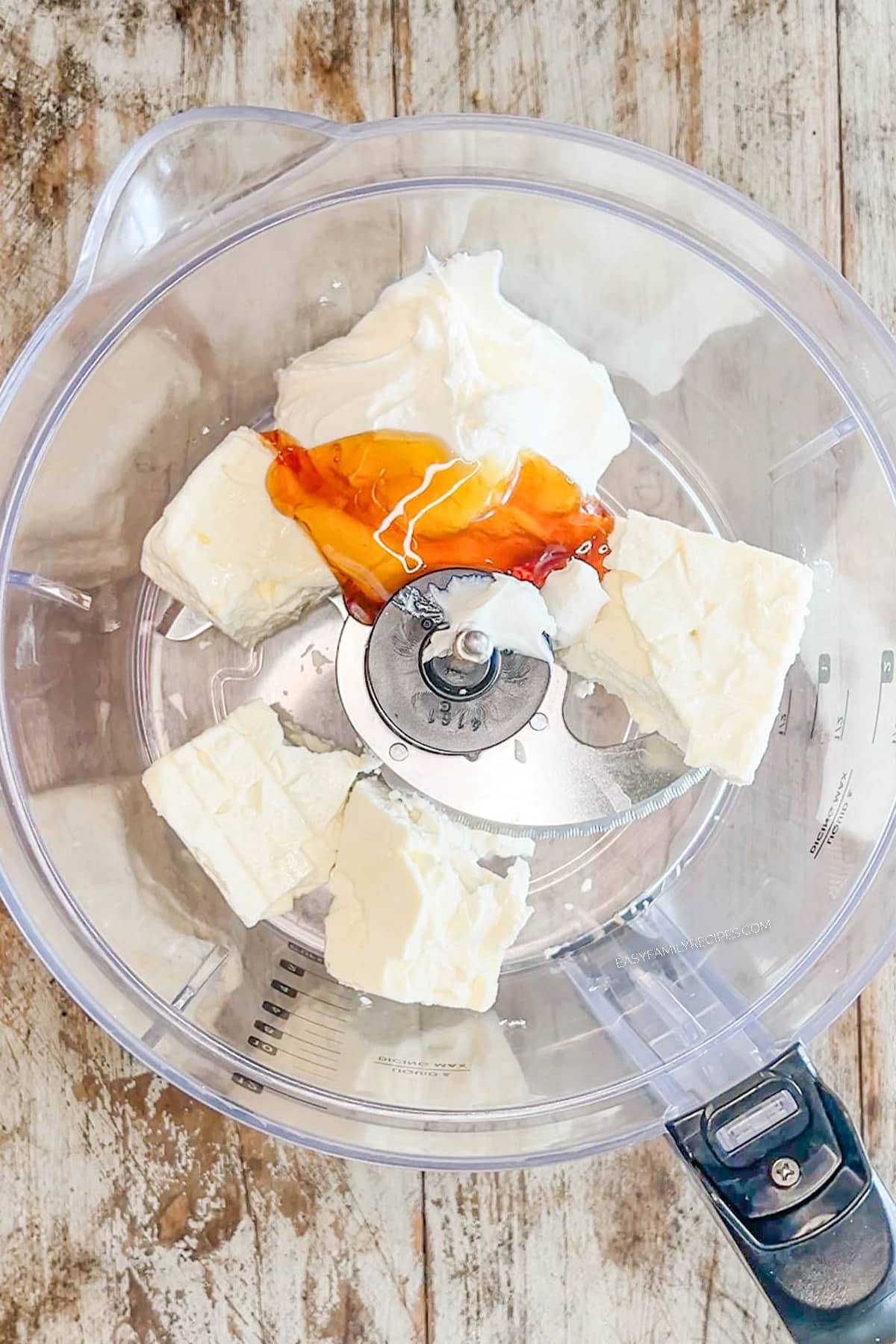 a block of feta and a drizzle of honey in a food processor.