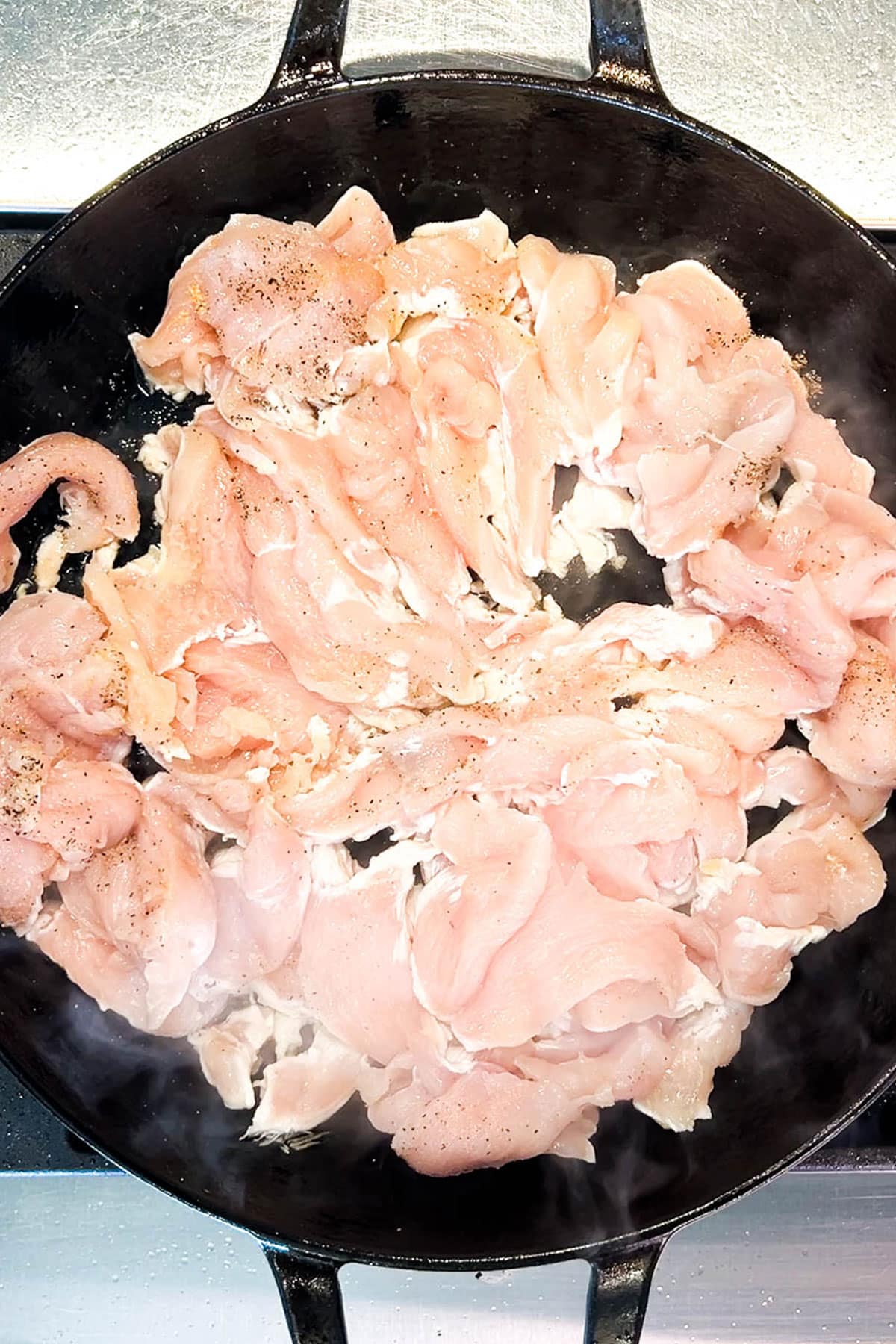 Step 2 for making chicken cheesesteak sandwiches: Saute the chicken. 