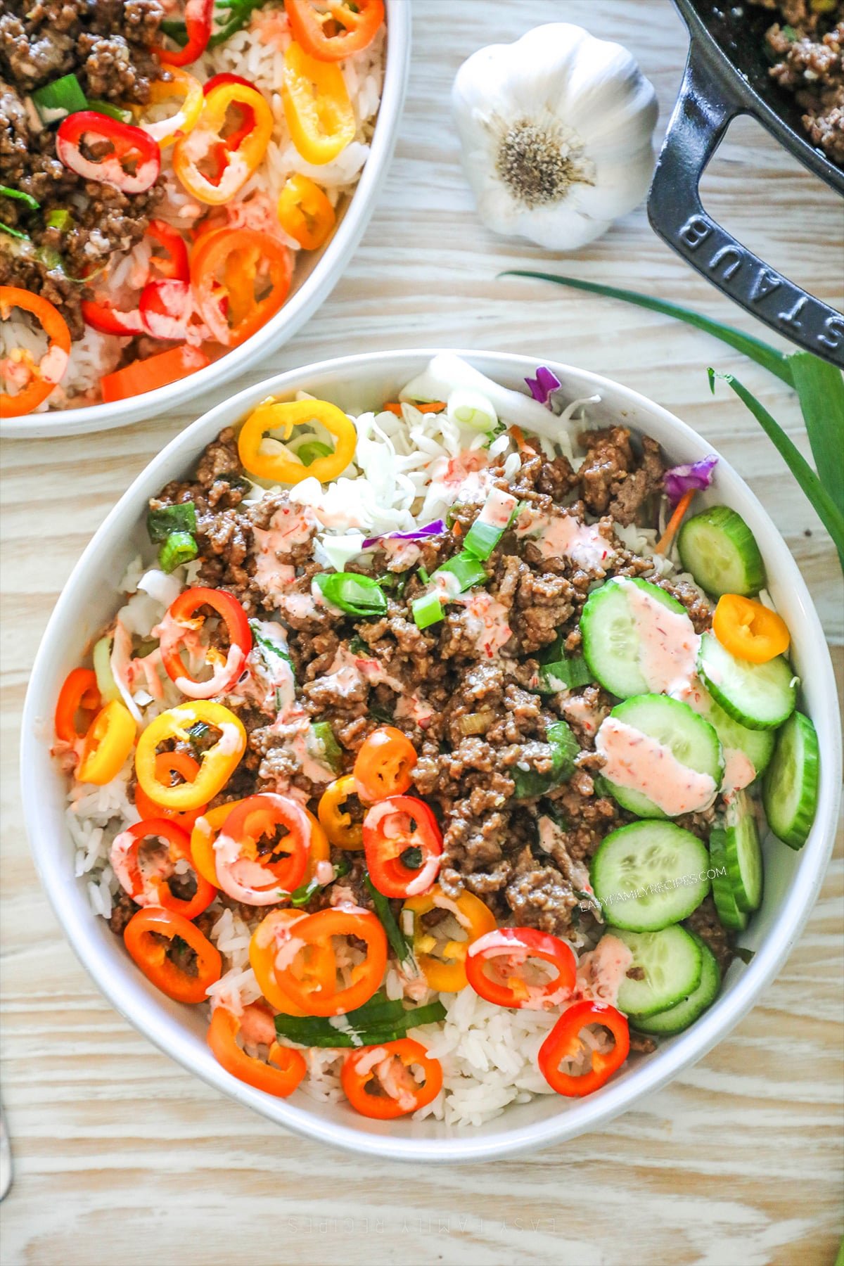 above image of a beef bulgogi bowl topped with sliced pepper and cucumber. 