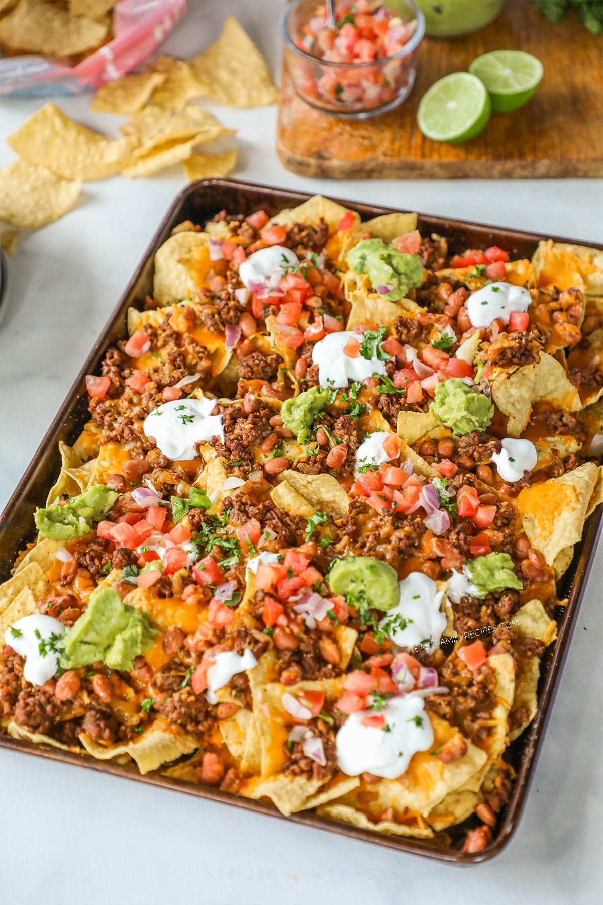 above image of sheet pan beef nachos.