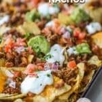 closeup of ground beef nachos in a pan.