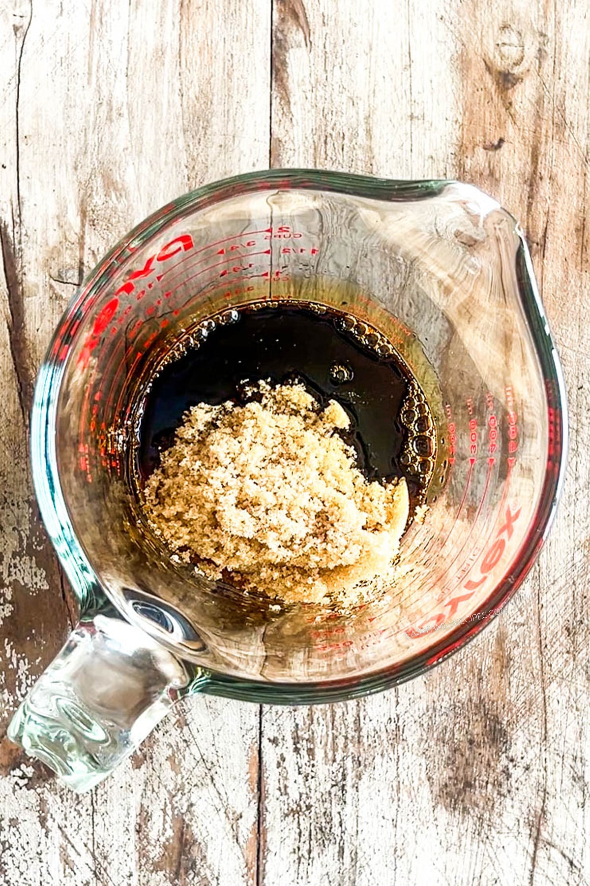 Step one for how to make Crockpot Bourbon Chicken: Add the sauce ingredients to a measuring cup.