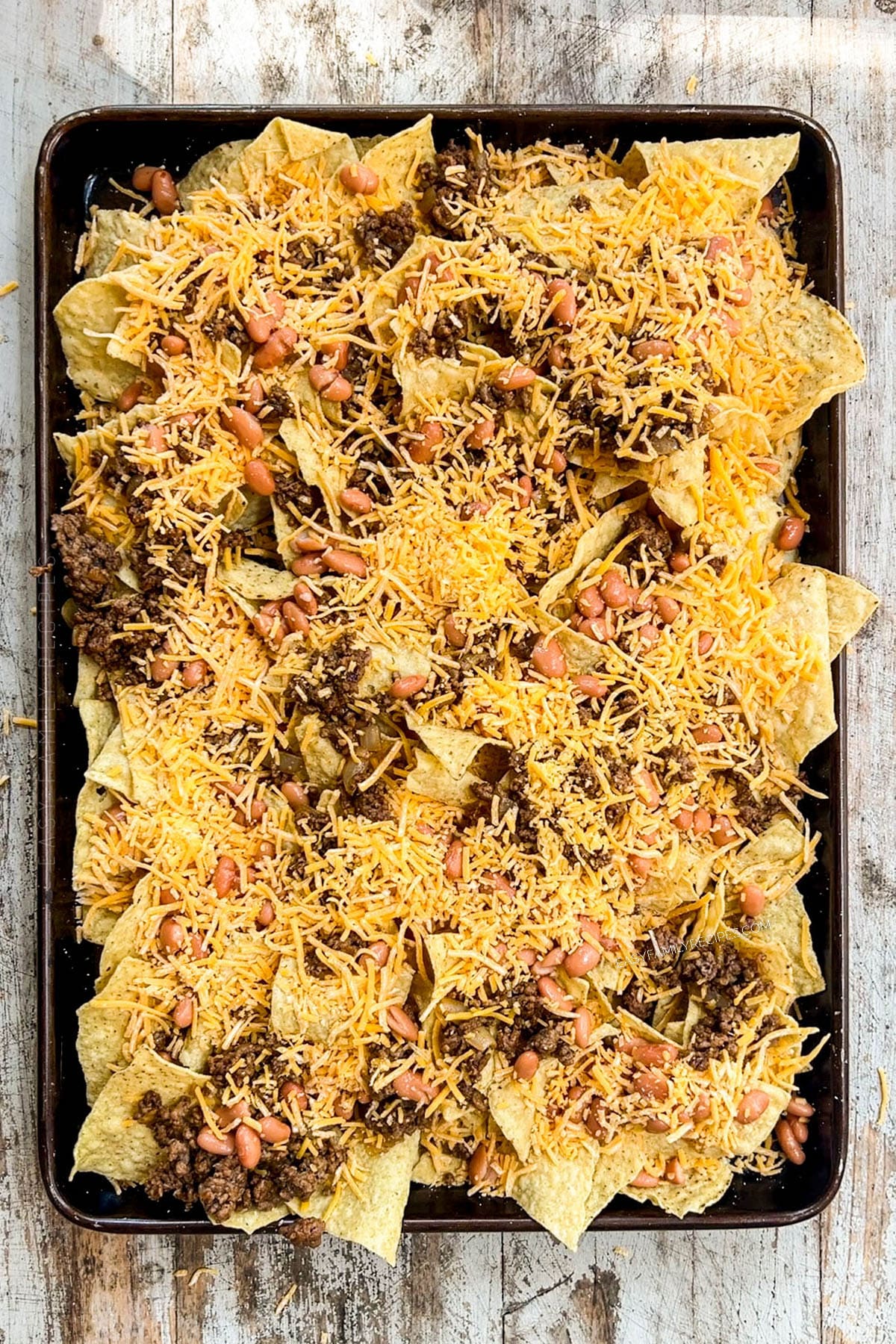 tortilla chips layered with ground beef and cheese.