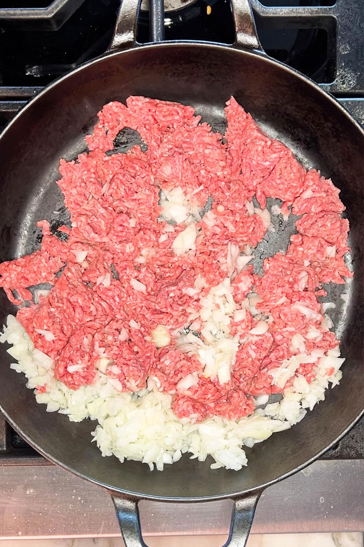 Step one for Loaded Mac & Cheese with Ground Beef - cook the onion and ground beef.