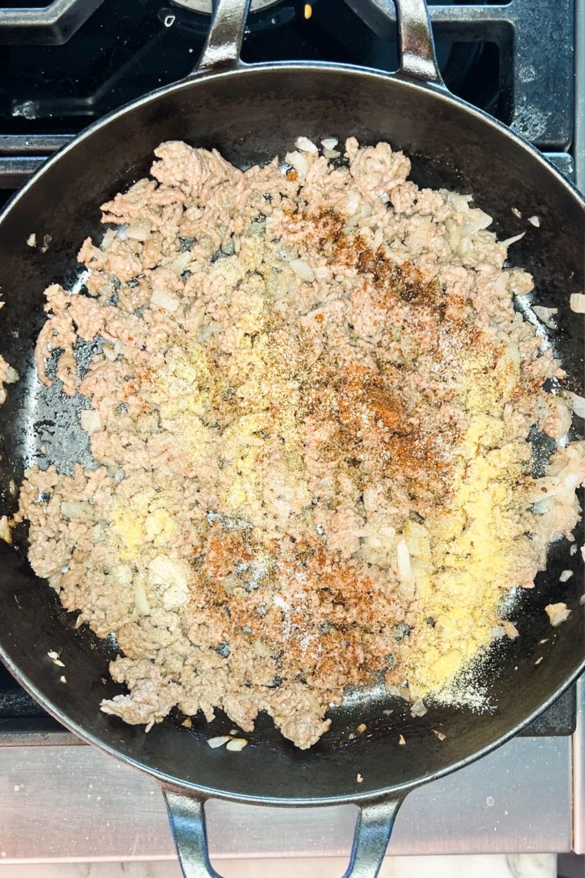 Step two for how to make Loaded Mac & Cheese with Ground Beef - add the seasonings