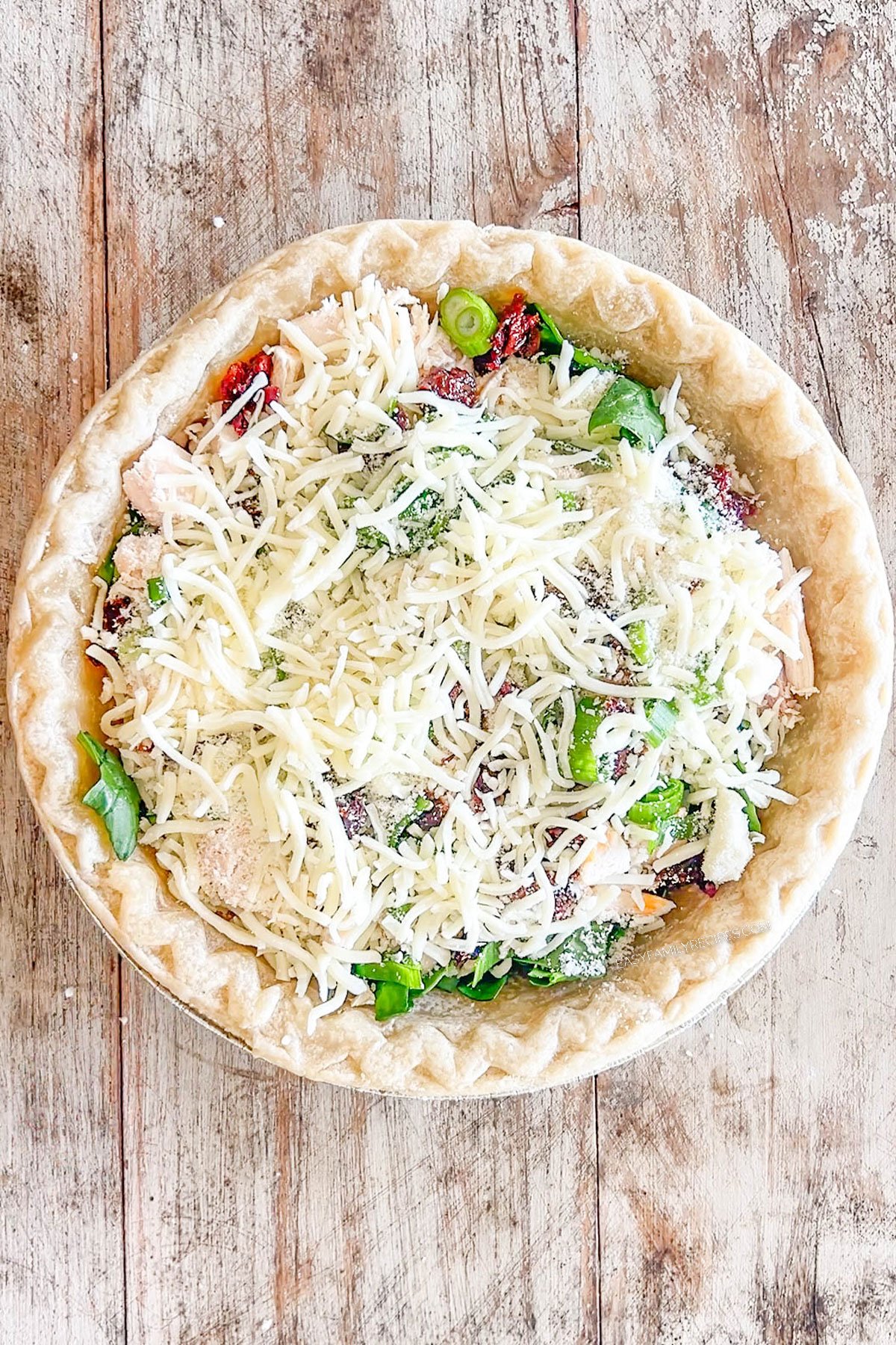 Step 4 of how to make Marry Me Chicken Quiche - add the cheese.