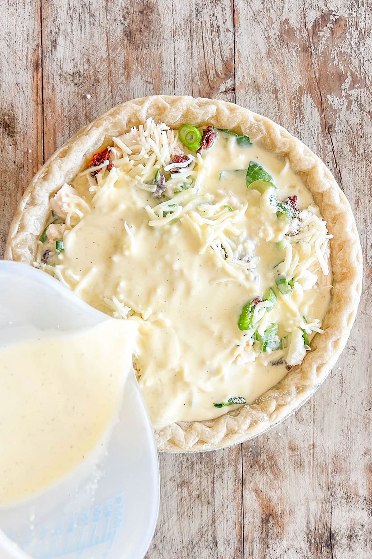 Step 5 of how to make Marry Me Chicken Quiche - pour in the egg mixture.