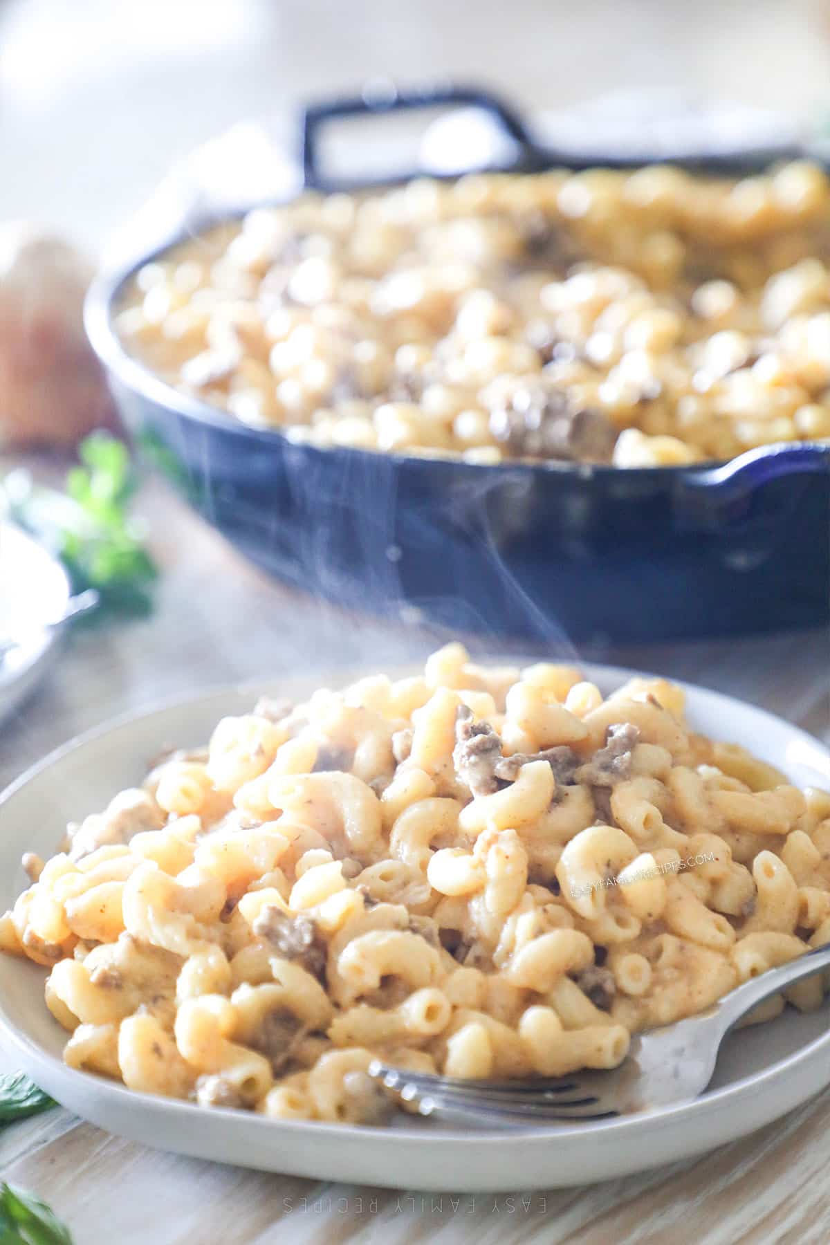 Loaded Mac & Cheese with Ground Beef on a white plate with a silver fork