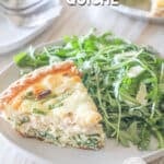 A slice of Marry Me Chicken Quiche on a white plate with a side salad. The text reads, "Marry Me Chicken Quiche"