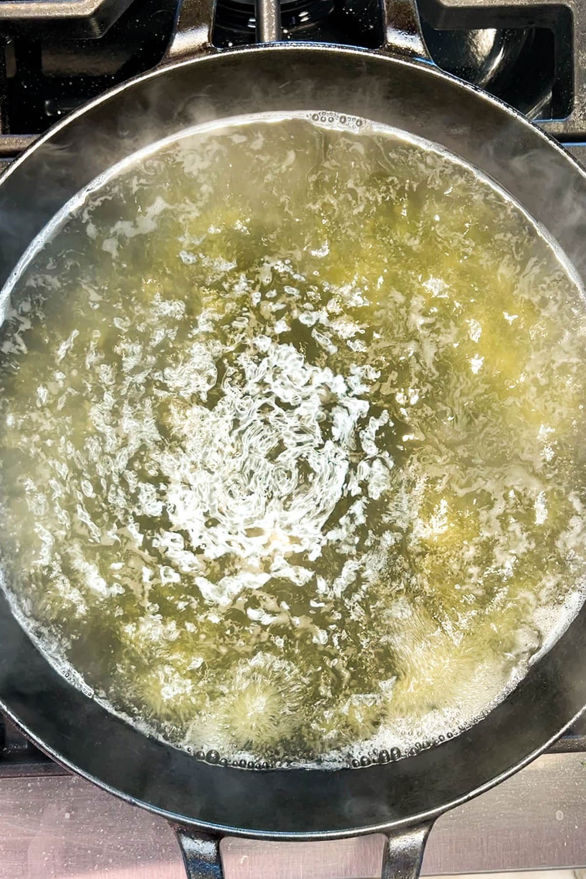 Step one for making cheesy grits with eggs: Cook the grits in water.