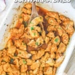 Top view of chicken schwarma bites in a baking dish with a wooden spoon. The text reads, “Chicken Schwarma Bites”