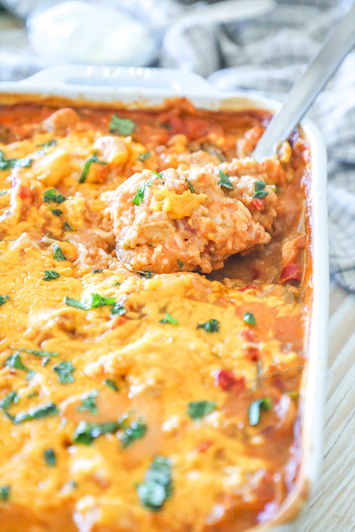 baked cheesy chicken rice in a casserole dish. 