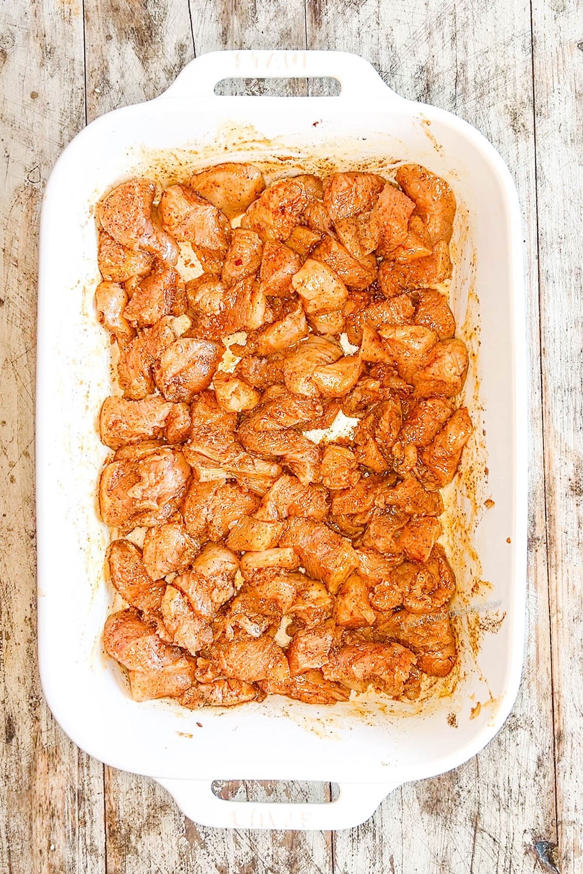 Step 3 for how to make chicken schwarma bites - toss the chicken with the seasonings, then bake