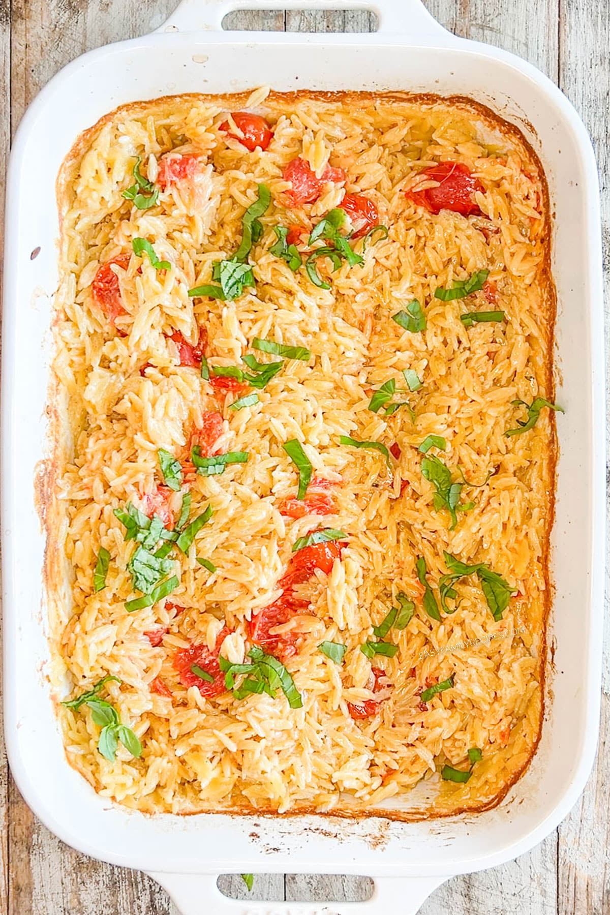 Top view of Boursin Baked Orzo in a white casserole dish, step 4 of how to make boursin orzo