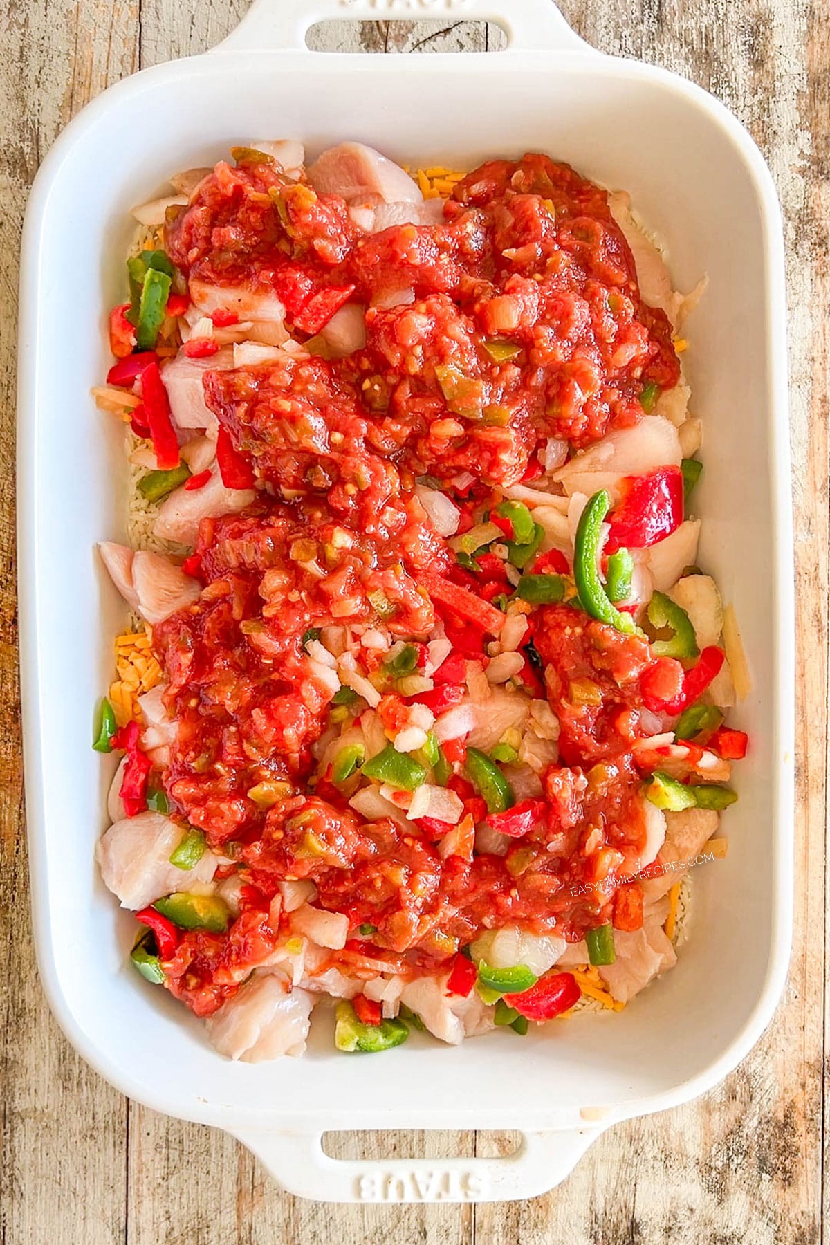 rice, chicken, and veggies in a casserole dish.